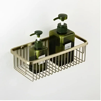 Brass wire mesh wall-mounted shelf with two dark green glass pump bottles in a decorbites brushed gold hardware set