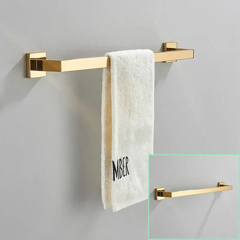 Modern brushed gold hardware set featuring a gold-finished rectangular towel rack with sleek square brackets decorbites brushed gold
