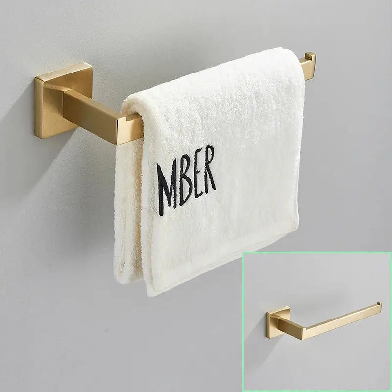 Modern brushed gold wall-mounted towel rack with square brackets holding a white towel from decorbites brushed gold hardware set