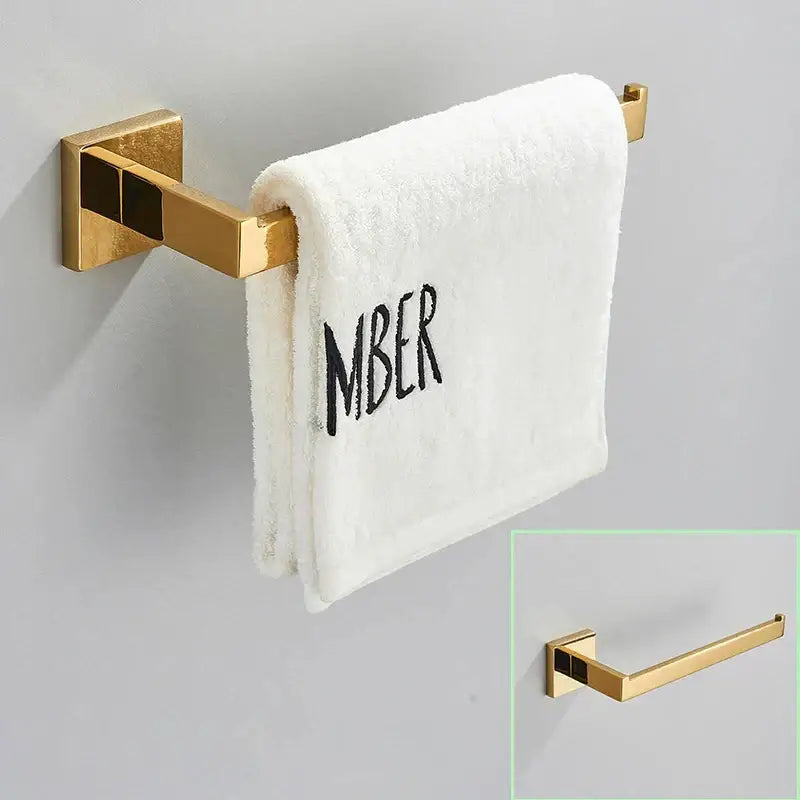 Modern brushed gold towel rack hardware set with square brackets holding white terry cloth towel decorbites brushed gold