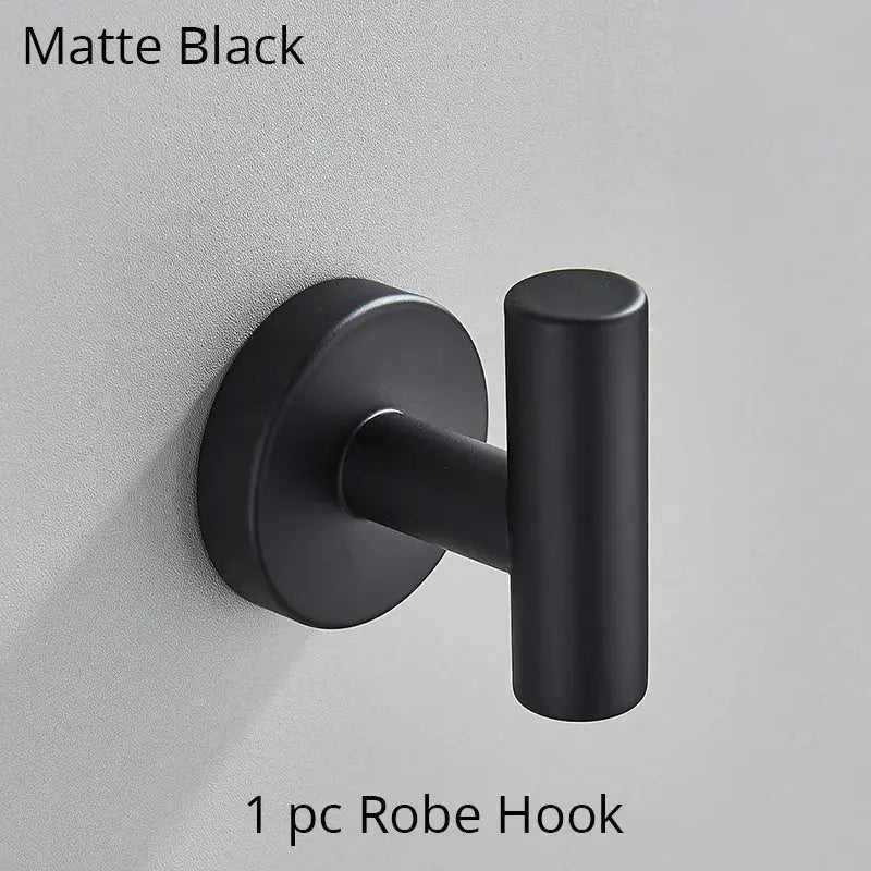 Matte black robe hook with sleek cylindrical design and circular base in modern brushed gold decorbites bathroom hardware set