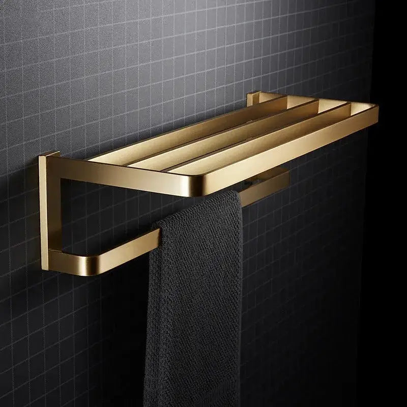 Modern brushed gold bathroom hardware set featuring a gold-toned towel rack with sleek metallic finish and three bars
