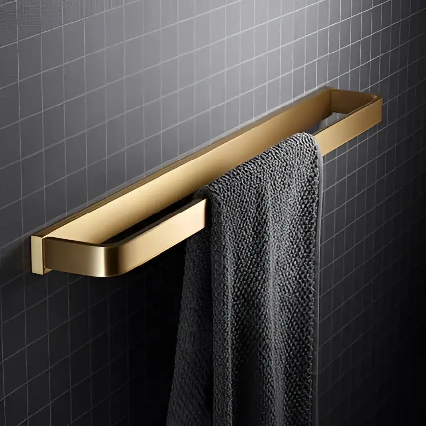 Modern brushed gold hardware set featuring a gold-toned rectangular towel rack with a sleek, modern design by decorbites