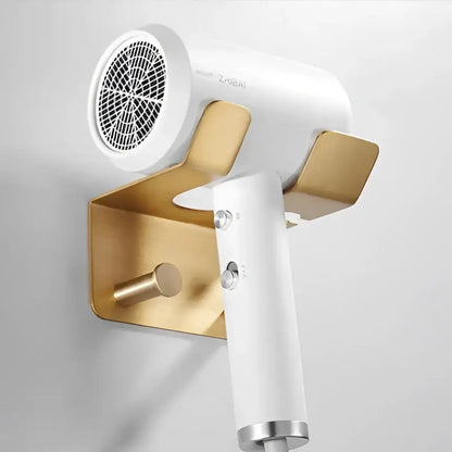 White zheji hair dryer mounted on a brushed gold wall holder from decorbites modern brushed gold hardware set