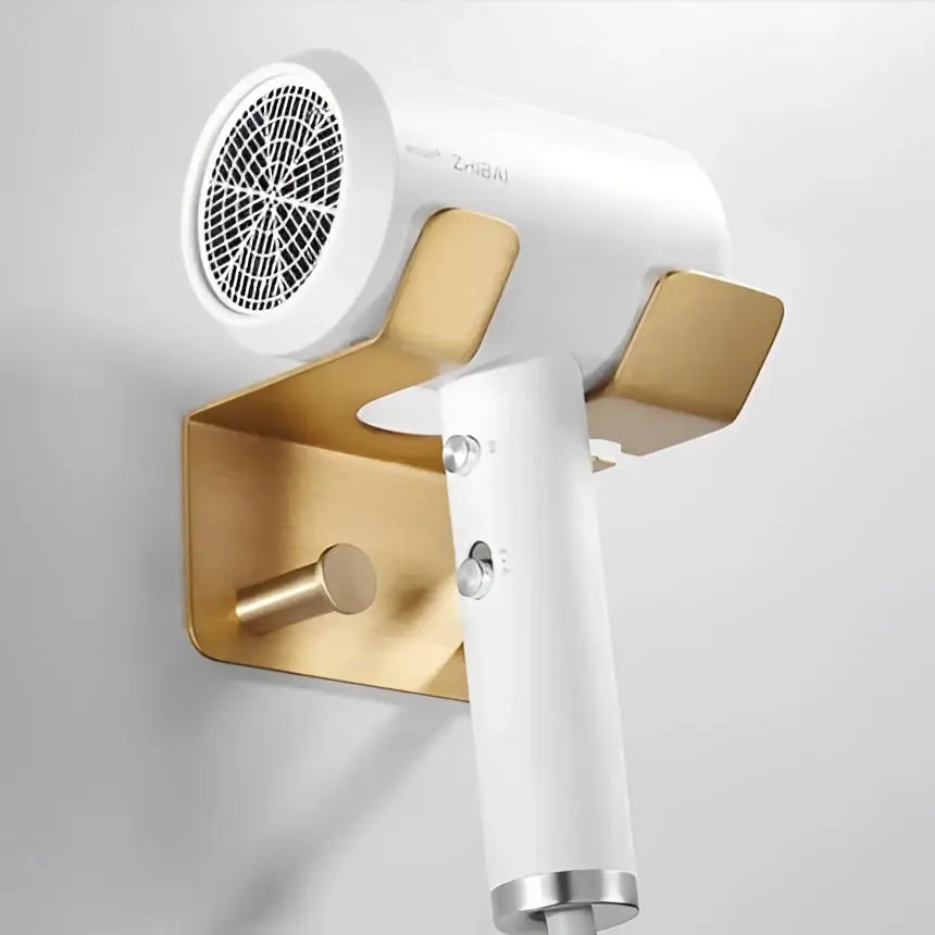 White zheji hair dryer mounted on a brushed gold wall holder from decorbites modern brushed gold hardware set