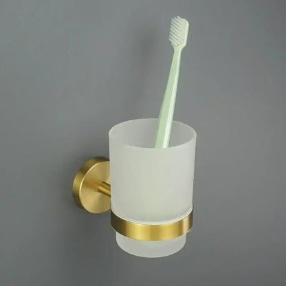 Modern brushed gold bathroom set featuring a gold-accented frosted glass toothbrush holder with sleek design decorbites brushed gold