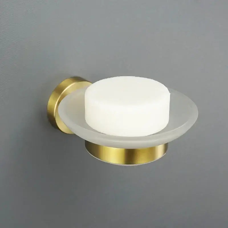 Modern brushed gold bathroom wall-mounted soap dish with frosted glass bowl holding white soap decorbites brushed gold