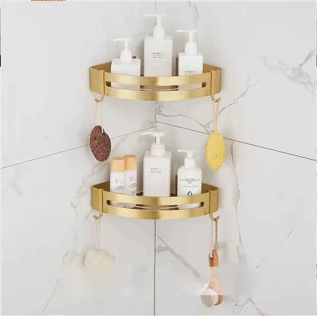 Modern brushed gold bathroom set featuring a gold two-tiered corner shelf with hooks for hanging bath accessories Decorbites brushed gold