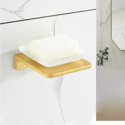 Gold-toned metal soap dish with sleek modern design holding white soap from decorbites brushed gold bathroom set
