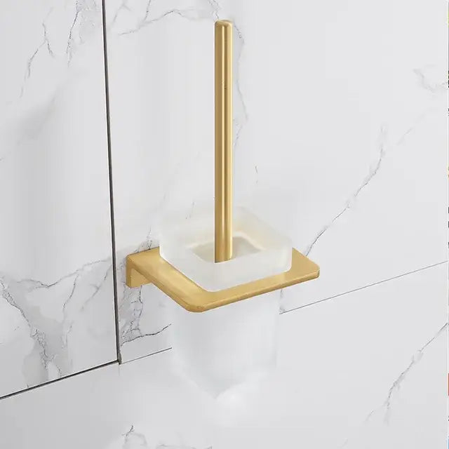 Modern brushed gold bathroom set with gold-toned toilet brush holder featuring a square brass base and acrylic cup