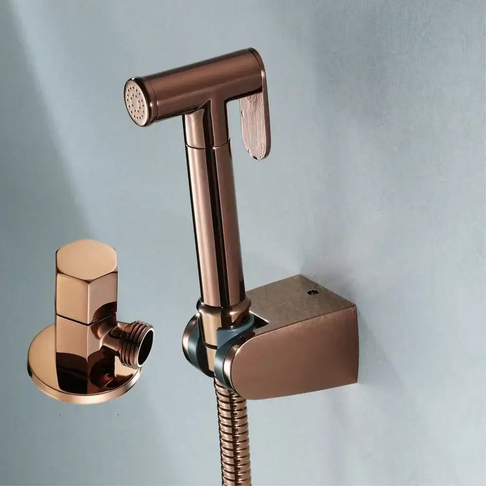 Modern brushed gold bidet sprayer kit featuring a rose gold bidet sprayer nozzle with matching wall-mounted bracket
