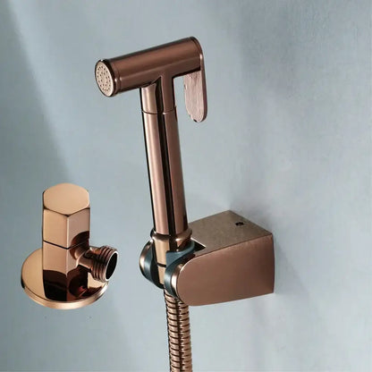 Modern brushed gold bidet sprayer kit featuring a rose gold bidet sprayer nozzle with matching wall-mounted bracket