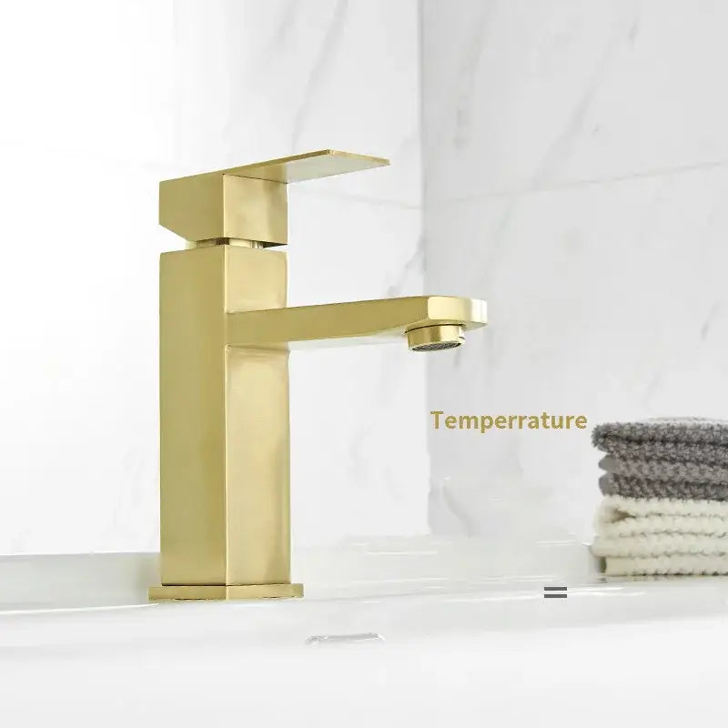 Modern brushed gold and black rectangular basin tap with sleek geometric design and brushed gold black finish for bathroom sink