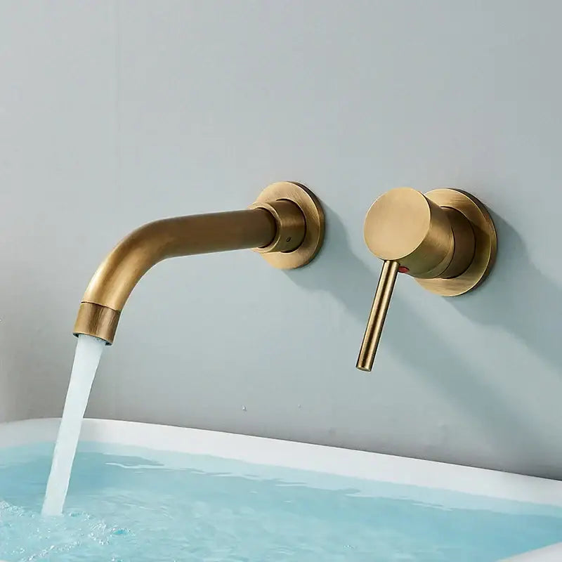 Modern brushed gold and black wall mounted basin faucet with curved spout and cylindrical handle in brass