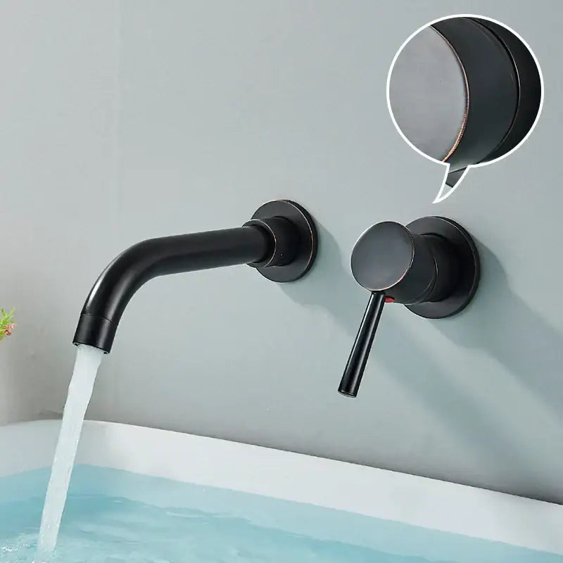 Modern brushed gold and black wall mounted basin faucet with black matte curved spout and round handle