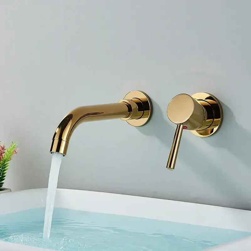 Modern brushed gold wall mounted basin faucet with sleek design and flowing water stream for bathroom use