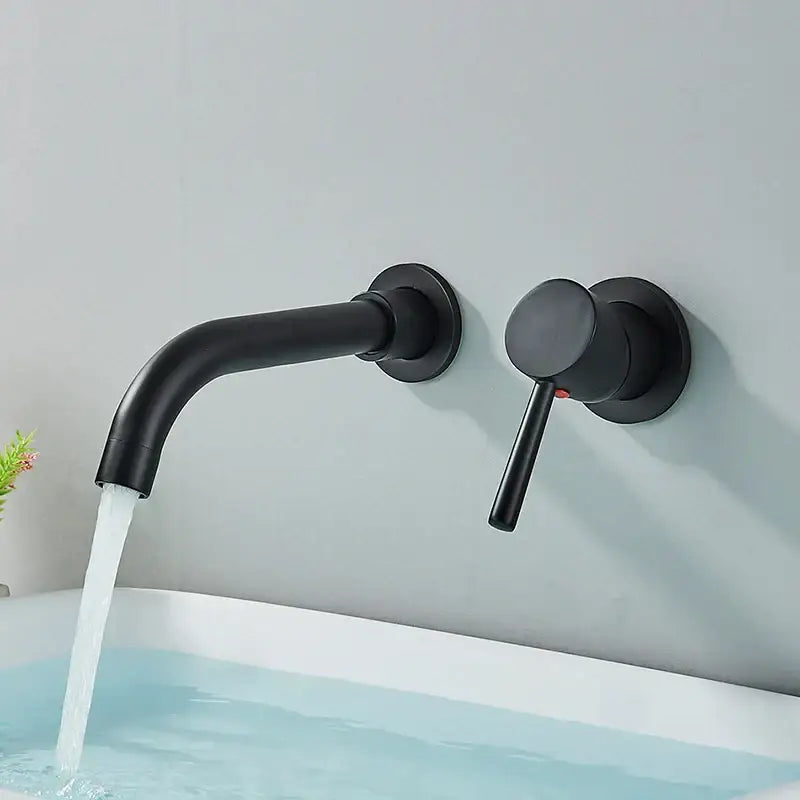 Modern brushed gold and black wall mounted basin faucet with black matte finish curved spout and cylindrical handle