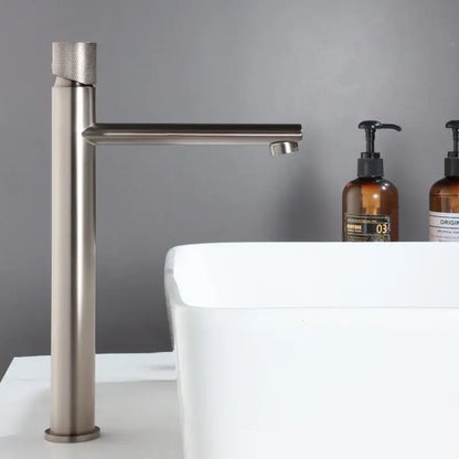 Modern brushed gold brass basin faucet with a textured cylindrical handle and sleek minimalist design for bathroom sink