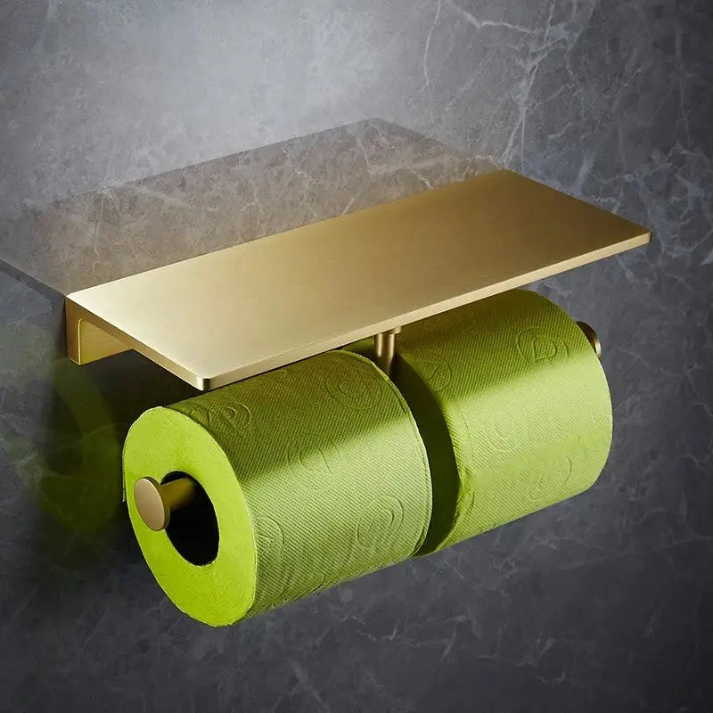 Modern brushed gold brass bath hardware set featuring a double toilet paper holder with a rectangular shelf and lime green tissue