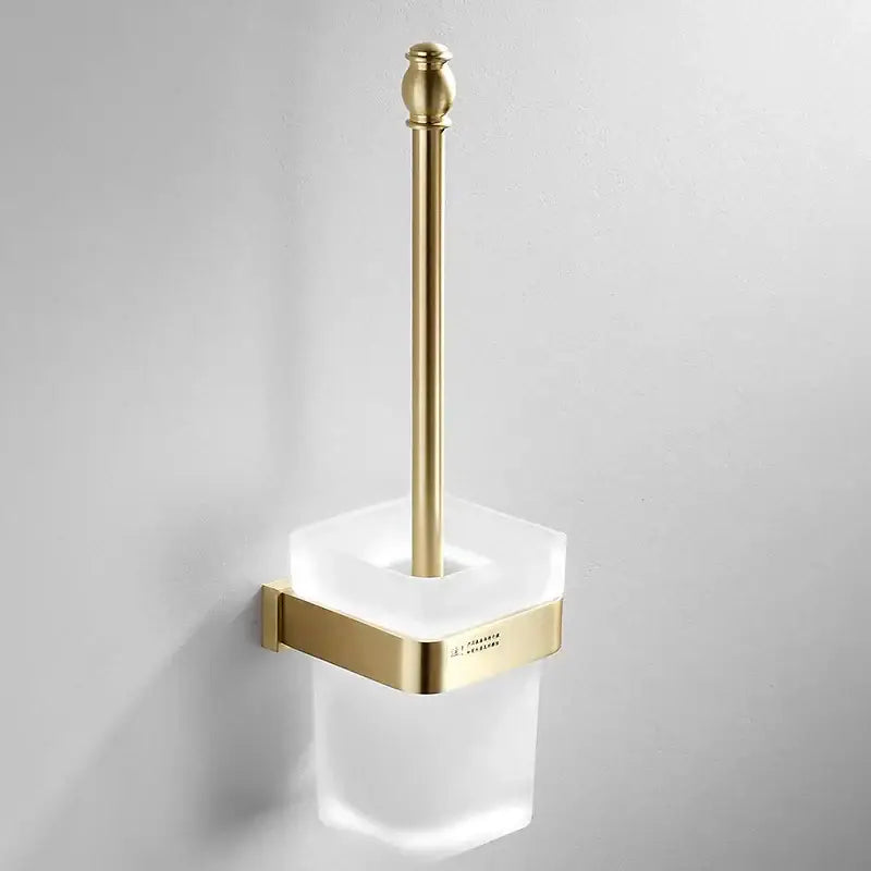 Modern brushed gold bath hardware set featuring a gold-finished toilet brush holder with frosted glass base and bracket