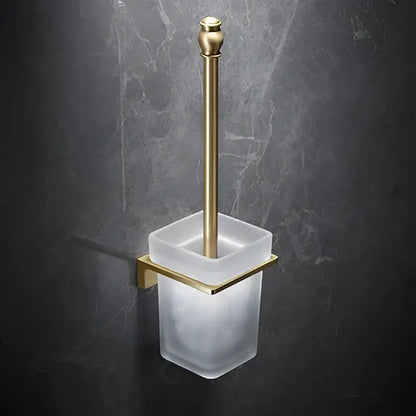 Modern brushed gold brass bath hardware set featuring a gold-toned toilet brush holder with frosted glass container and bracket