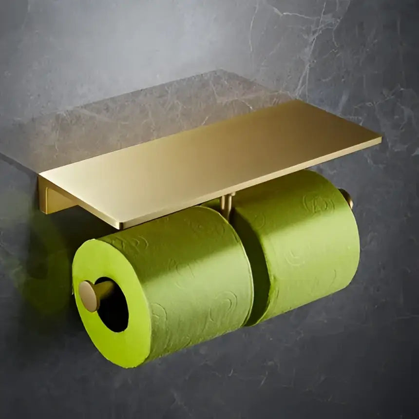 Gold-toned double toilet paper holder with rectangular shelf and lime green rolls in modern brushed gold bath hardware set