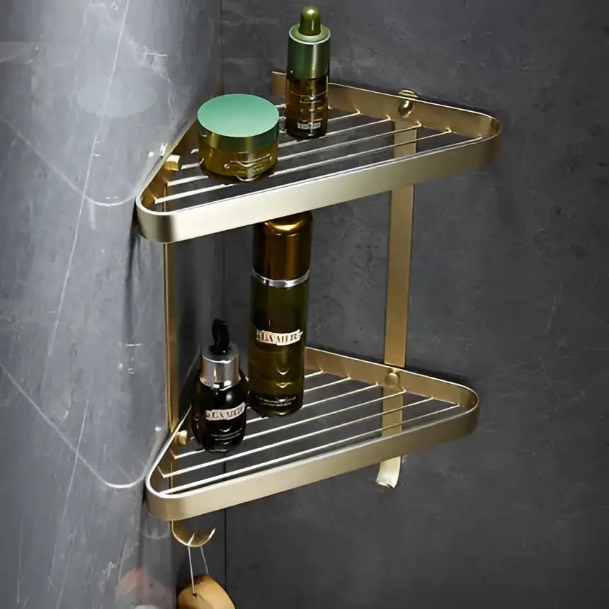 Modern brushed gold brass bath hardware set featuring a gold-toned triangular corner shower caddy with two tiers