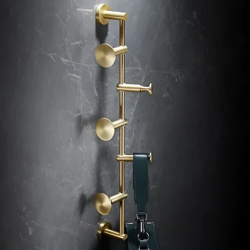 Modern brushed gold brass bath hardware set wall-mounted hook rack with circular knobs and dark green leather bag hanging