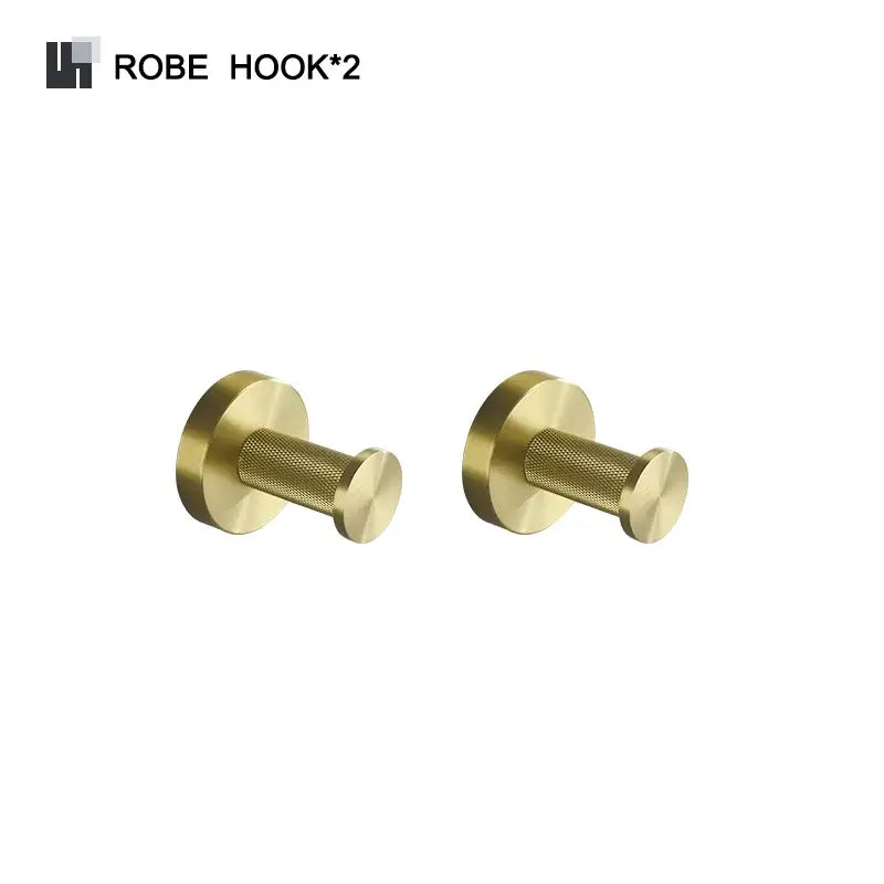 Pair of brushed gold brass robe hooks with textured cylindrical bodies in a modern bathroom accessories set