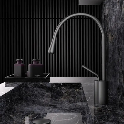 Modern brushed gold brass kitchen faucet with matte black finish, sleek curved spout, and cylindrical base for sink use