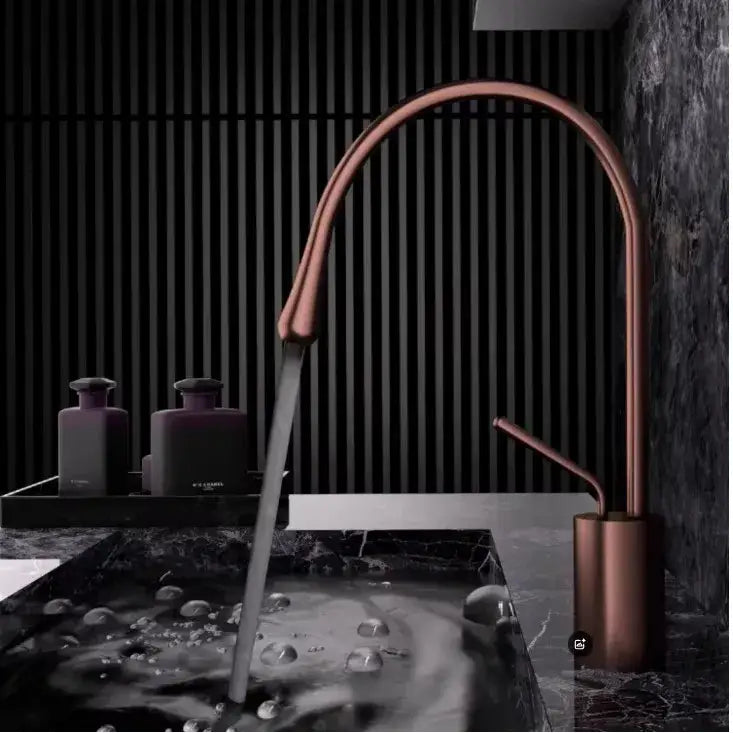 Modern brushed gold brass kitchen faucet with copper finish, sleek curved spout, and cylindrical base for sink use
