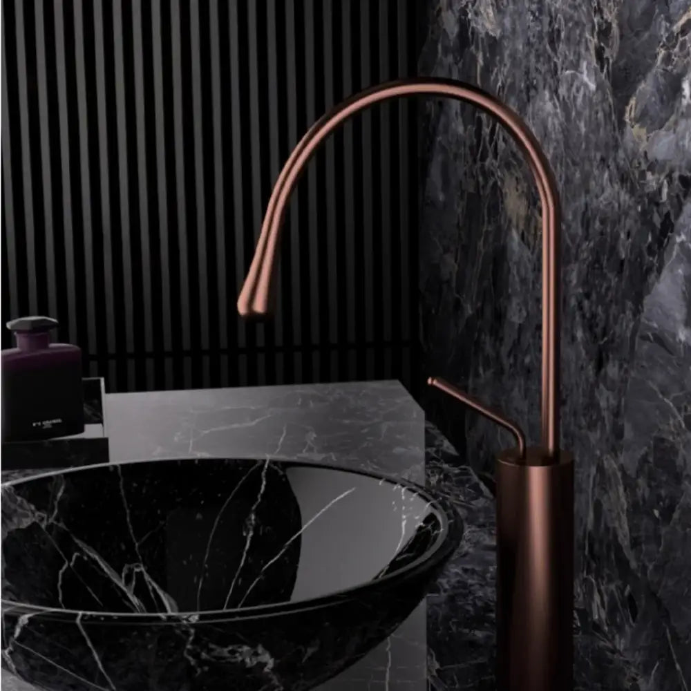 Modern brushed gold brass kitchen faucet with copper finish, sleek curved spout, and cylindrical base for sink use