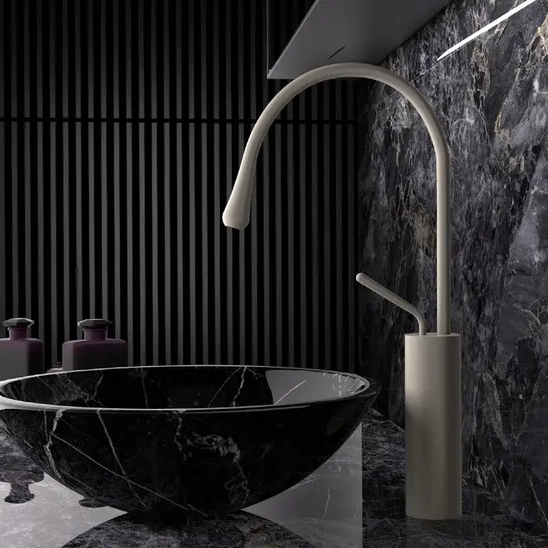 Modern white ceramic faucet with sleek curved spout in a brushed gold brass kitchen sink tap design
