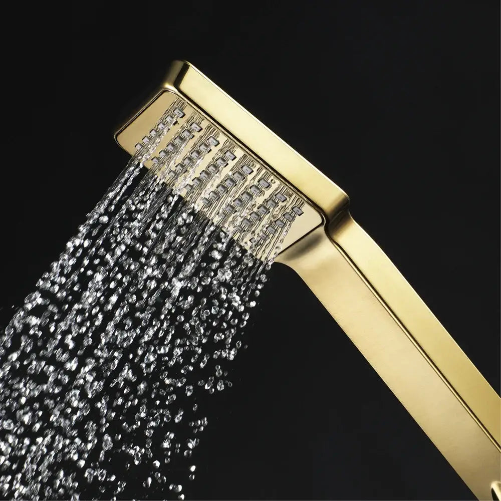 Modern brushed gold hand bidet sprayer kit with gold rectangular showerhead spraying multiple water jets in cascading pattern