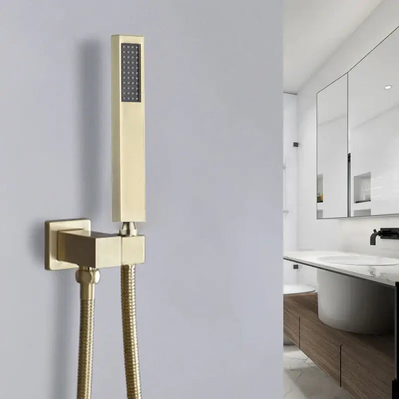 Modern brushed gold hand shower with textured spray face and stainless steel hose in a sleek rectangular design