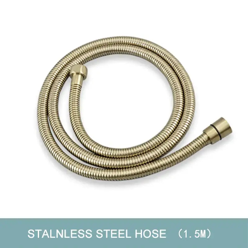 A coiled stainless steel hose with brushed gold finish and threaded connectors for modern hand shower use