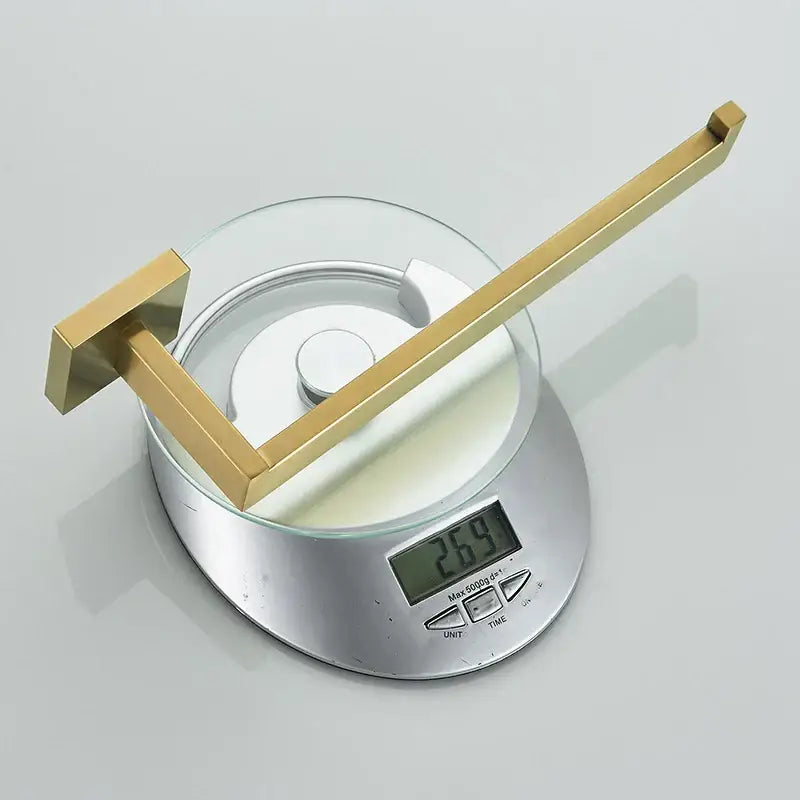 Gold-toned brass toilet paper holder with sleek modern design and square-ended bar from decorbites brushed gold hardware set