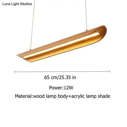 A modern brushed gold kitchen island light with a curved wooden body and acrylic shade for chandeliers kitchen island
