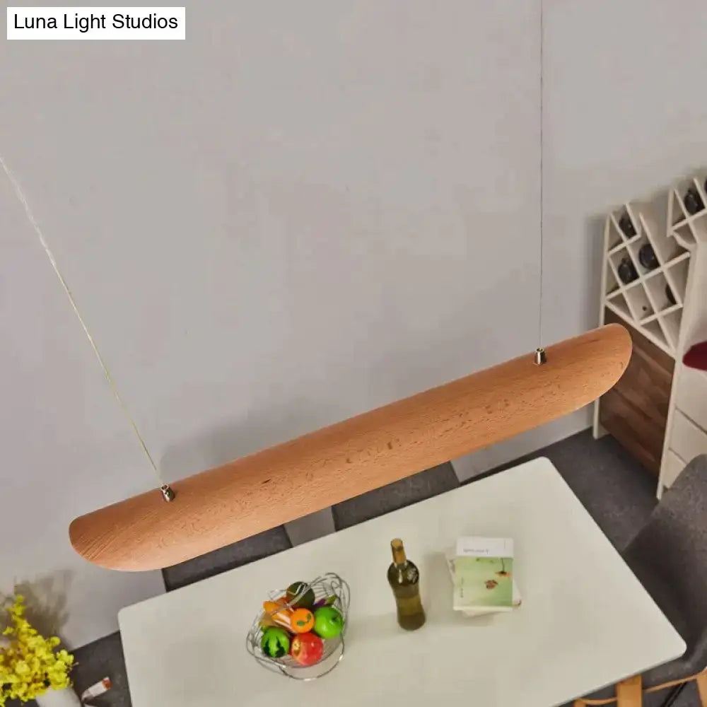 A sleek light brown wooden pendant lamp with metal suspension perfect as a kitchen island light or chandeliers kitchen island