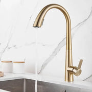 Modern brushed gold kitchen sink faucet with a sleek curved spout and pull-down spray head for kitchen sink use