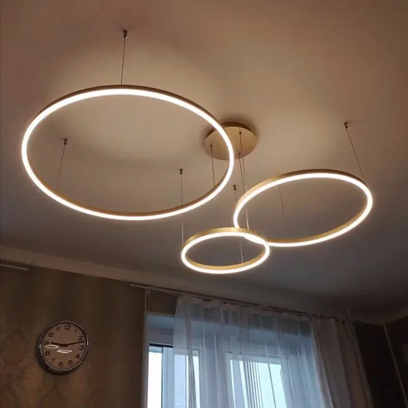 Modern brushed gold led chandelier featuring a circular design with warm white light for dining room decorbites brushed gold