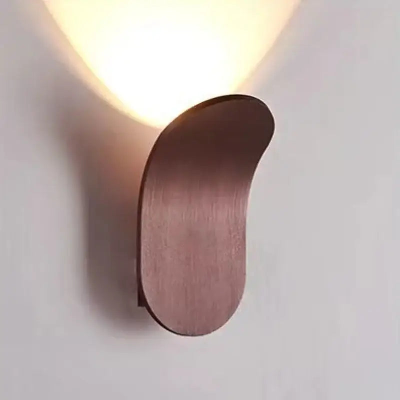 Modern brushed gold led wall lamp with curved design and brushed copper finish providing warm illumination