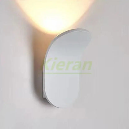 Modern brushed gold led wall lamp with sleek curved design and soft warm light for living room use