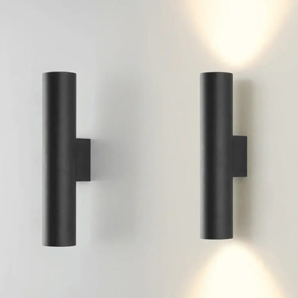 Modern brushed gold and matte black cylindrical wall lights featuring minimalist cylindrical wall lamps for bedroom lighting