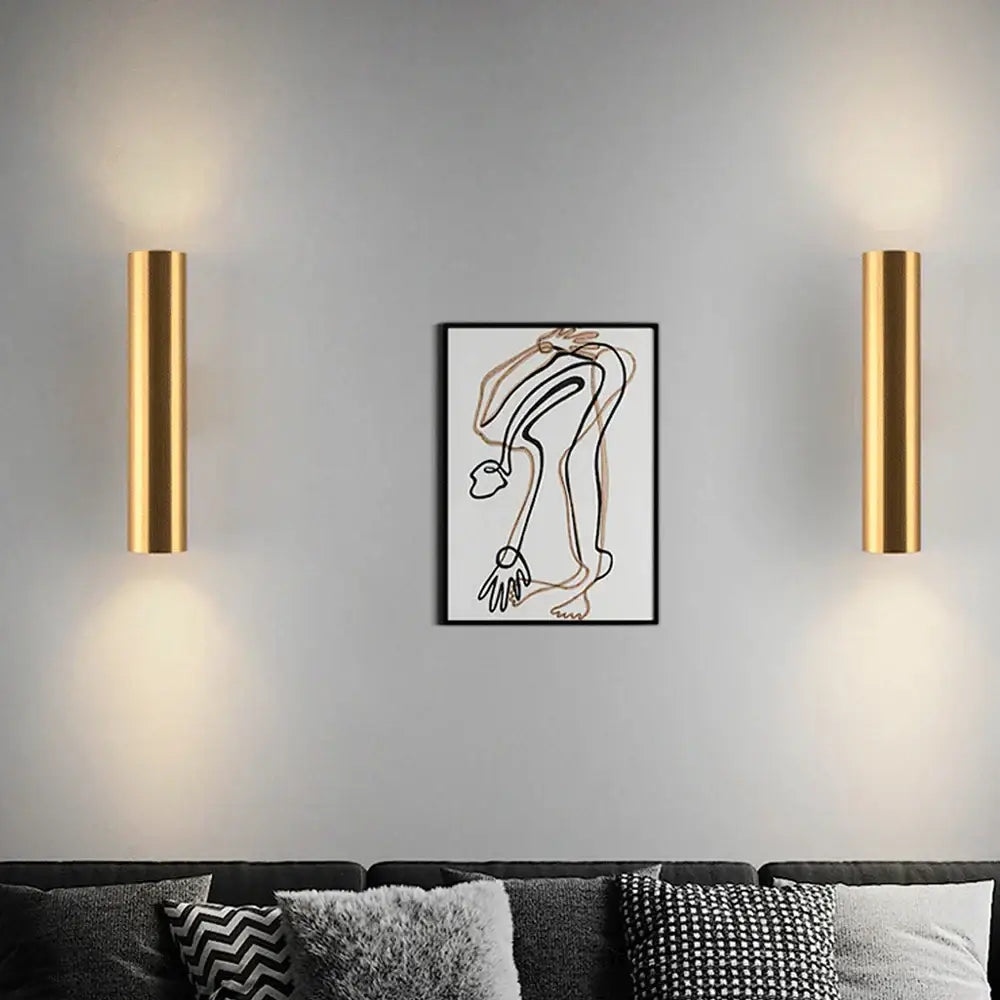 Modern brushed gold cylindrical wall lights with sleek design, ideal as wall lamps for bedroom lighting