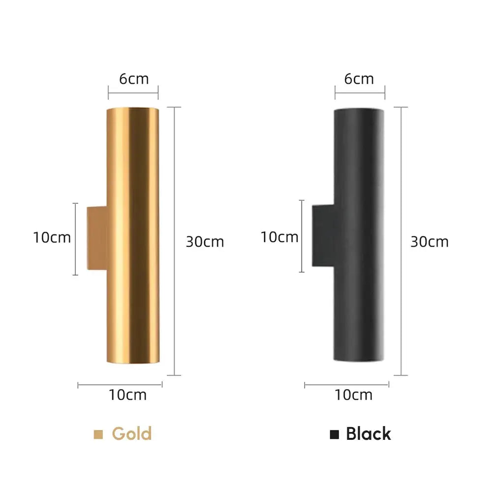 Modern brushed gold and matte black cylindrical wall lights featuring sleek finishes as bedroom wall lamps