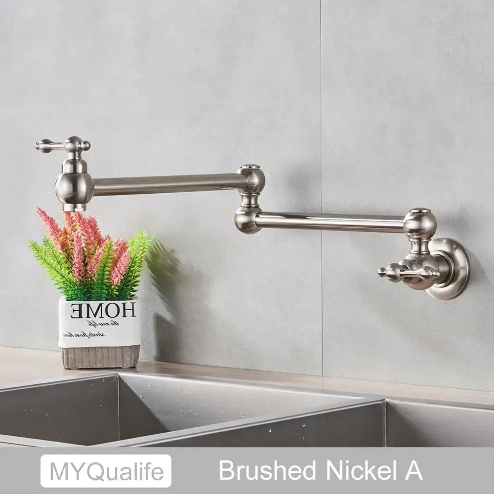 Modern brushed nickel pot filler faucet with wall-mounted articulated design and ornate handles for kitchen use