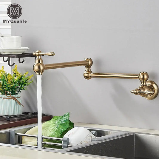 Modern brushed gold pot filler faucet with brass-colored extendable folding spout and ornate handles for kitchen use