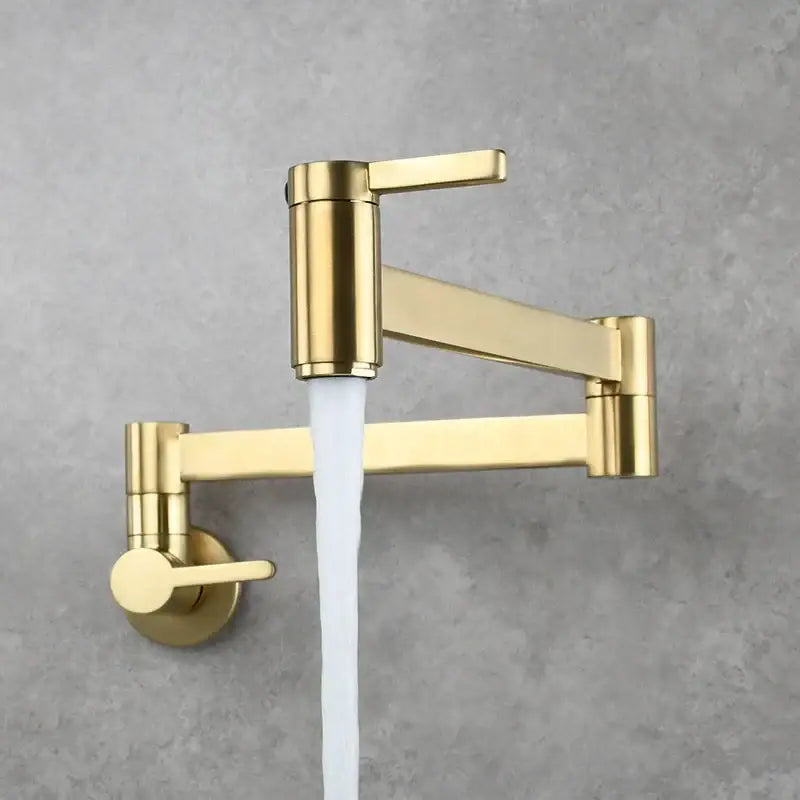 Modern brushed gold pot filler faucet wall mounted with sleek foldable spout and flowing water stream