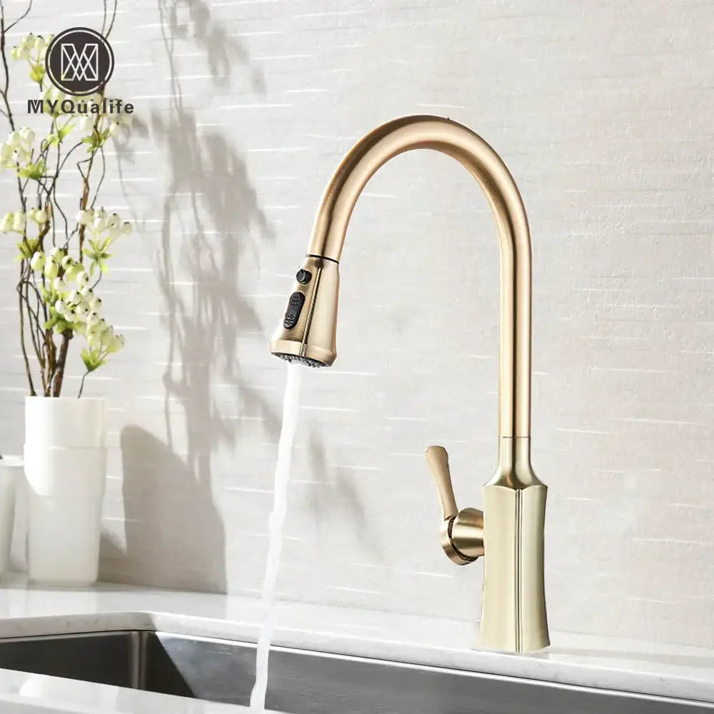 Brass-finished modern kitchen faucet with sleek curved spout and pull-down spray head by decorbites brushed gold